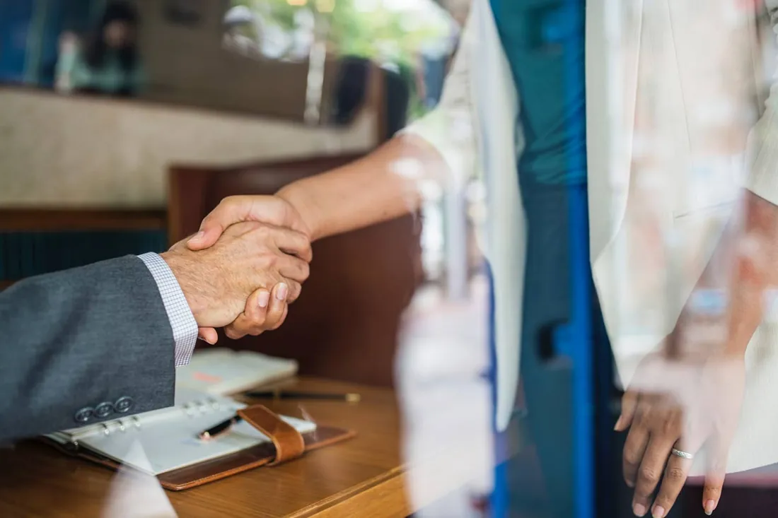 Hotel professional shaking hands with a partner